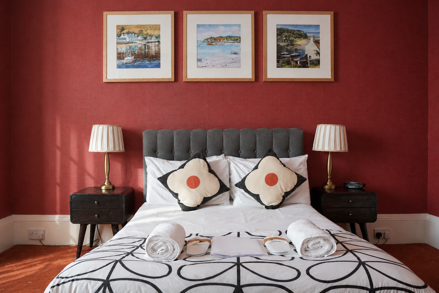 Guest room bed with red Victorian wall at Gladstone House
